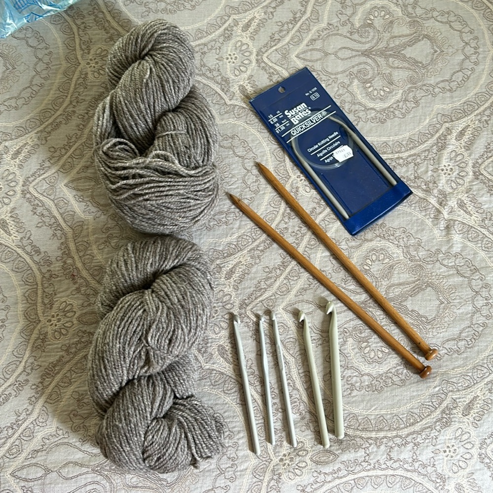 Bundle of assorted crochet and knitting needles with 2 large skeins of 100% wool